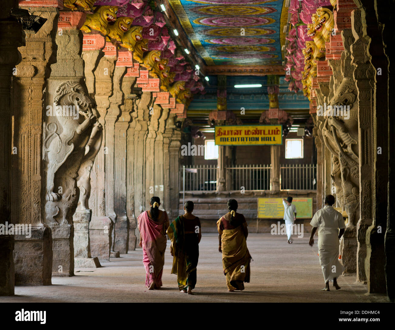 Visitors in the temple hall with brightly painted pillars, mythical creatures, Meenakshi Amman Temple or Sri Meenakshi Stock Photo