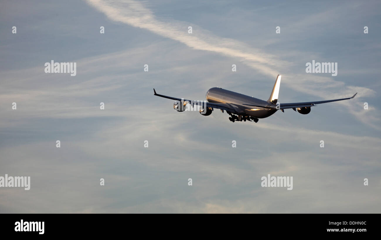 Germany, Bavaria, Munich, View of airbus a 340-600 departing at sunset Stock Photo