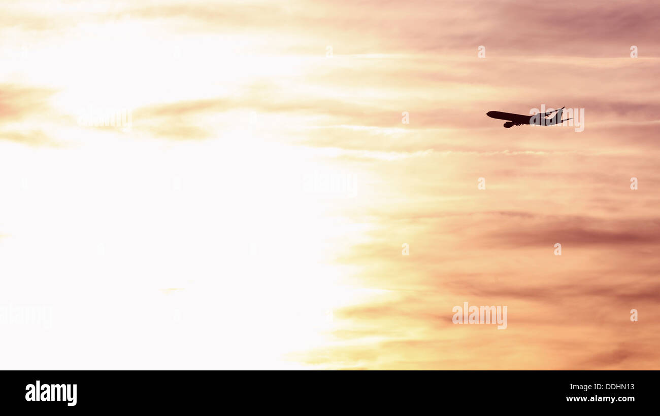 Germany, Bavaria, Munich, View of airbus a 340-600 departing at sunset Stock Photo