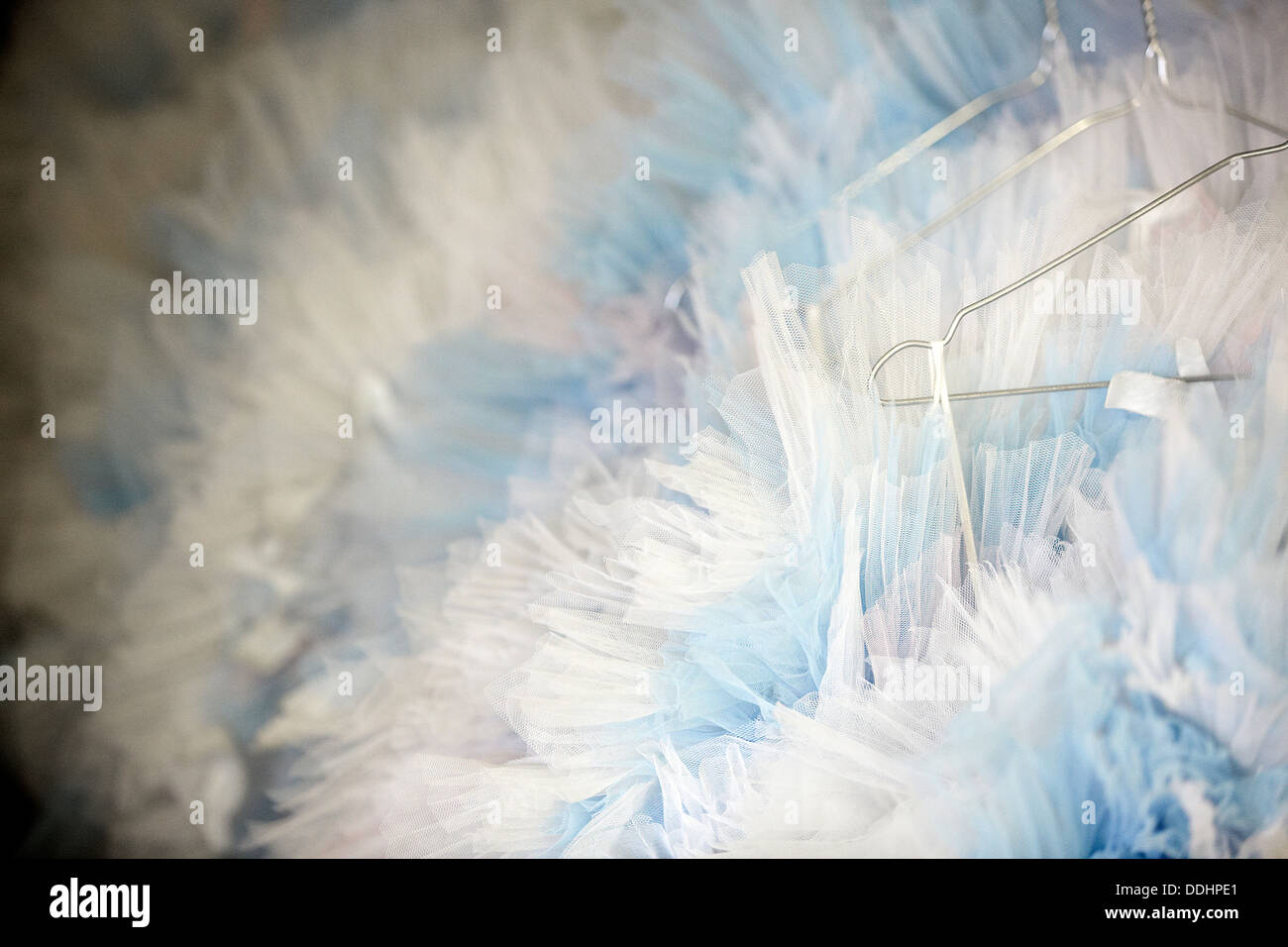 Close up details of tutus hanging up on wire coat hangers Stock Photo