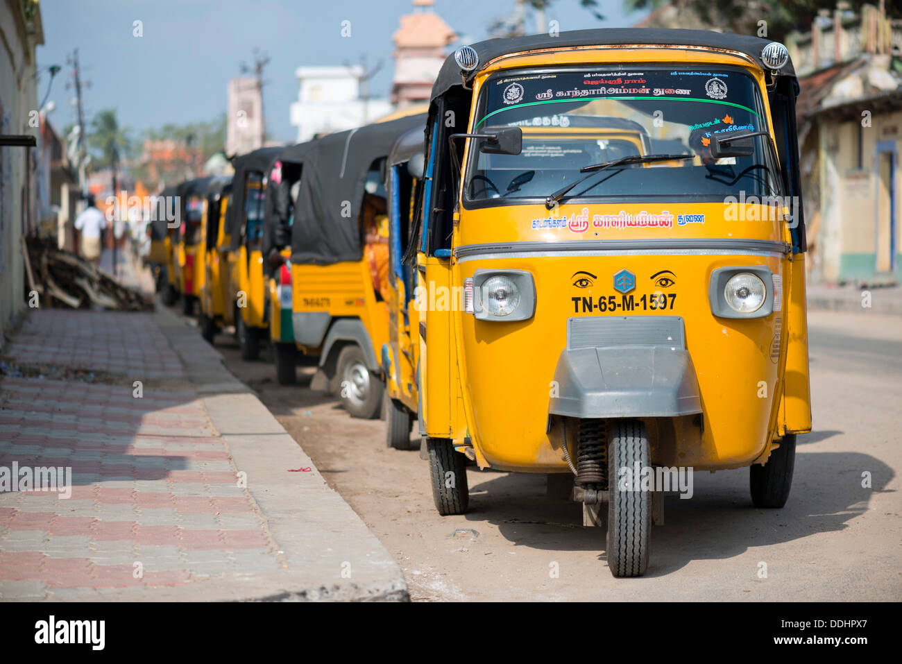 Row of yellow rickshaw taxis Stock Photo