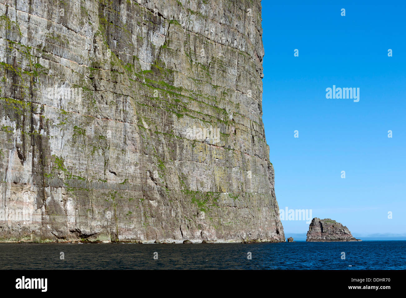 Cliffs and sea, rock formation off the beach Stock Photo