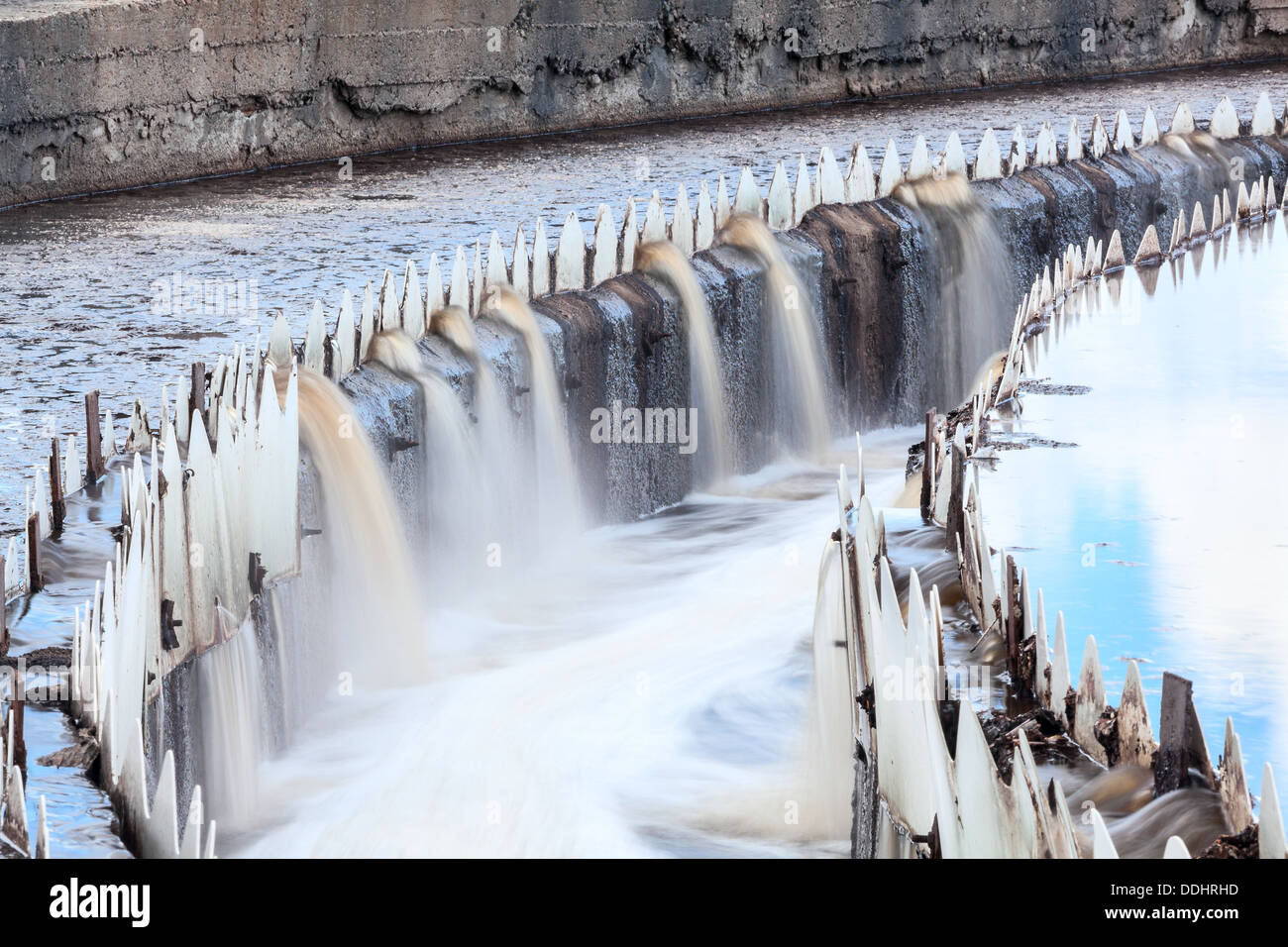 Water overflowing from round settlers, long exposure Stock Photo - Alamy