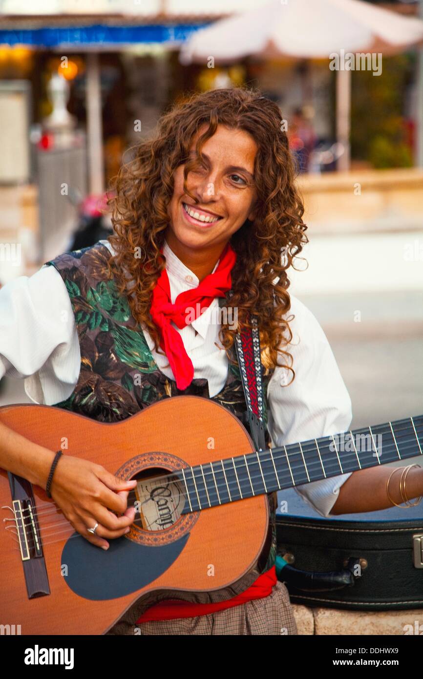 Woman playing guitar. Popular Festivals in Sant Vicenç beach Stock ...