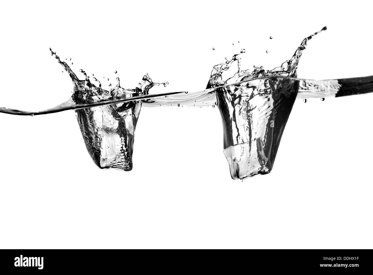 ice cubes dropped into water with splash isolated on white Stock Photo ...