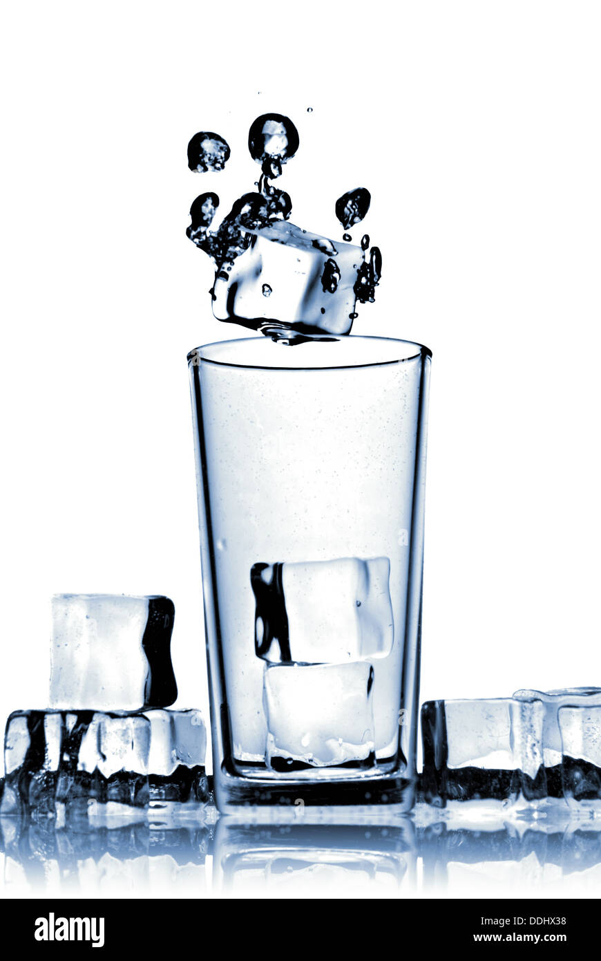 ice cubes dropped into glass with bubbles isolated on white Stock Photo ...