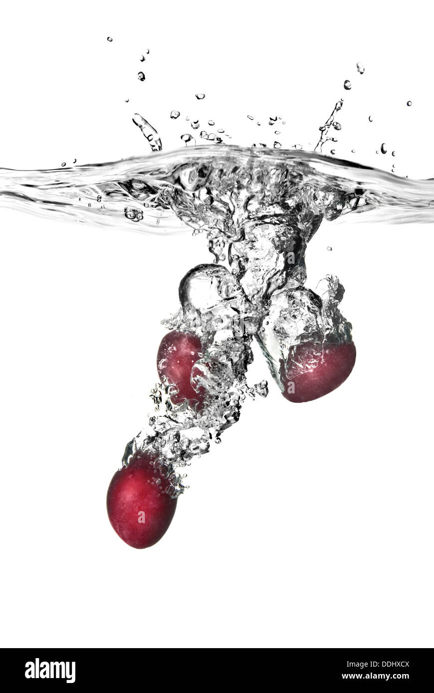 plum dropped into water with bubbles isolated on white Stock Photo Alamy
