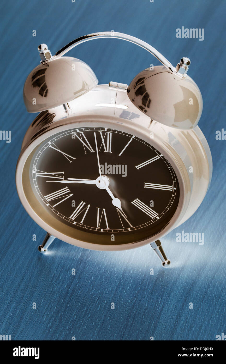 Negative Image of Alarm Clock, blue background, Stock Photo