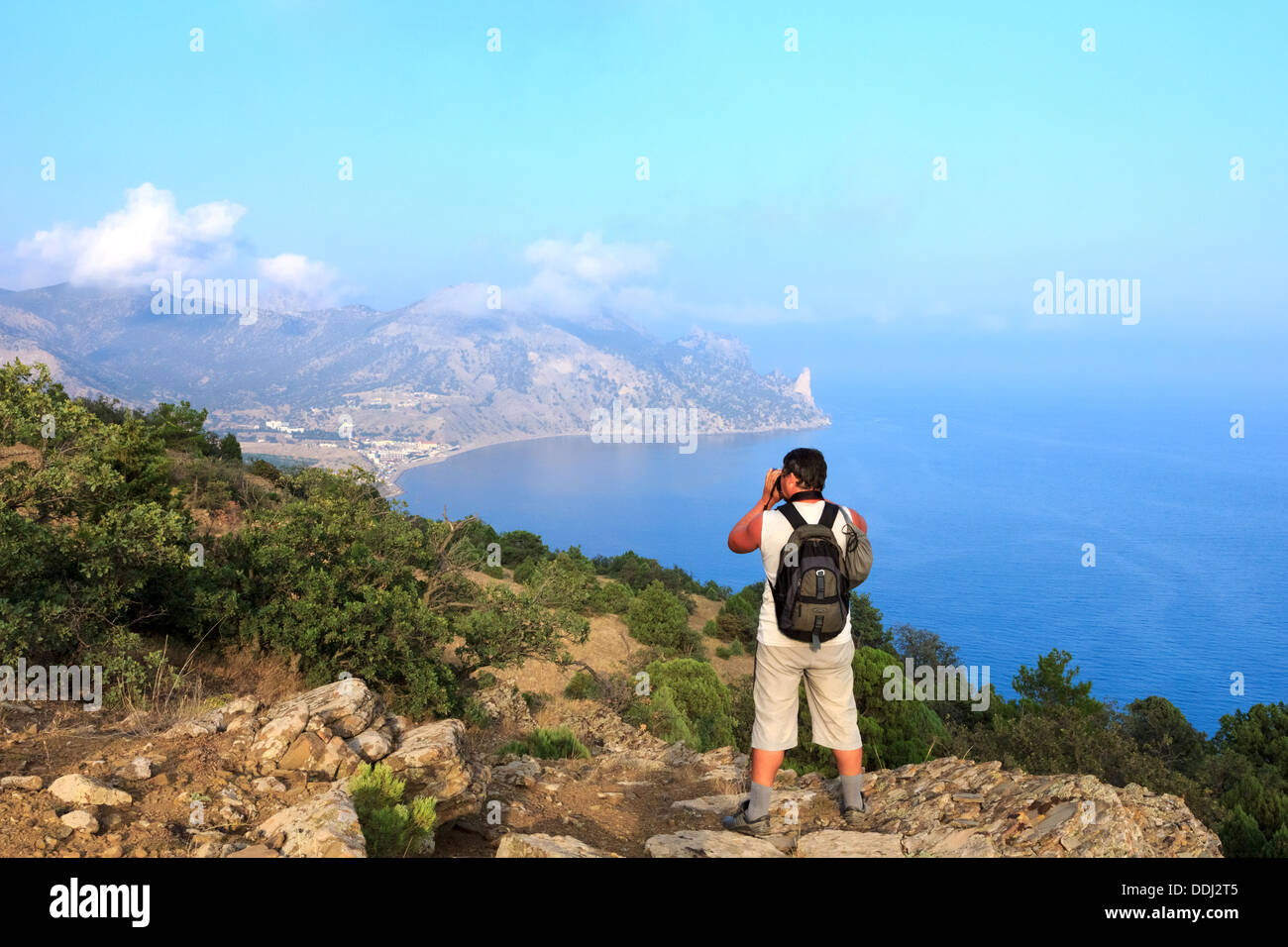 Photographer-traveler photographs the beautiful sea Crimean landscape from the top of the mountain, Karaul-Oba, Sudak, Crimea Stock Photo