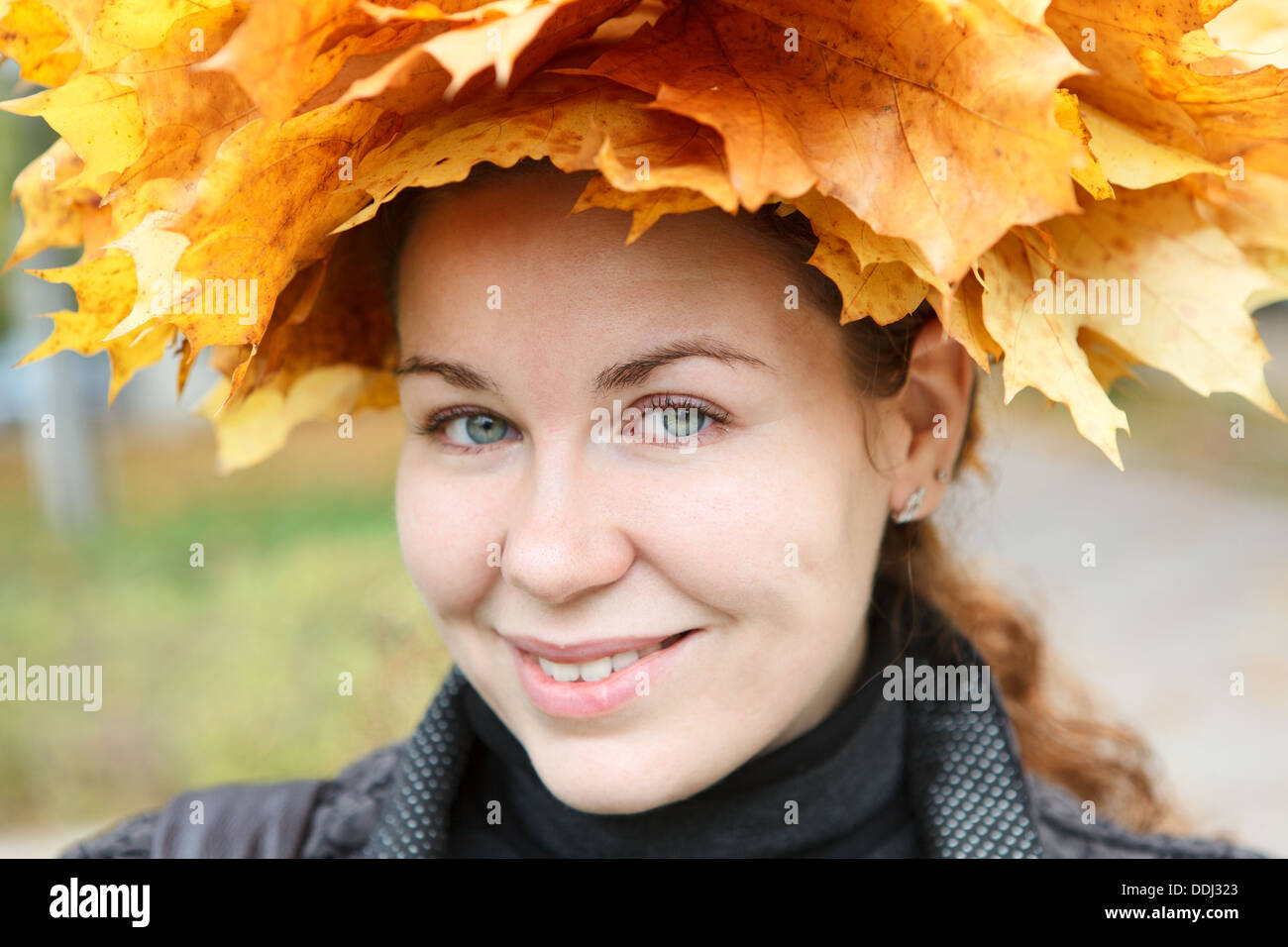 Portrait of happy smiling woman with maple wreath Stock Photo - Alamy