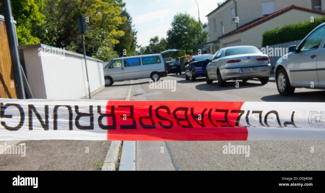 Ingolstadt, Germany. 03rd Sep, 2013. View of a police cordon in front of a barrier of a crime scene in a residential area in Ingolstadt, Germany, 03 September 2013. A man was shot dead in the street. The crime scene is protected from view by blue walls. Residents heard shots in the early morning and called the police which found a corpse lying on the sidewalk. Photo: PETER KNEFFEL/dpa/Alamy Live News Stock Photo
