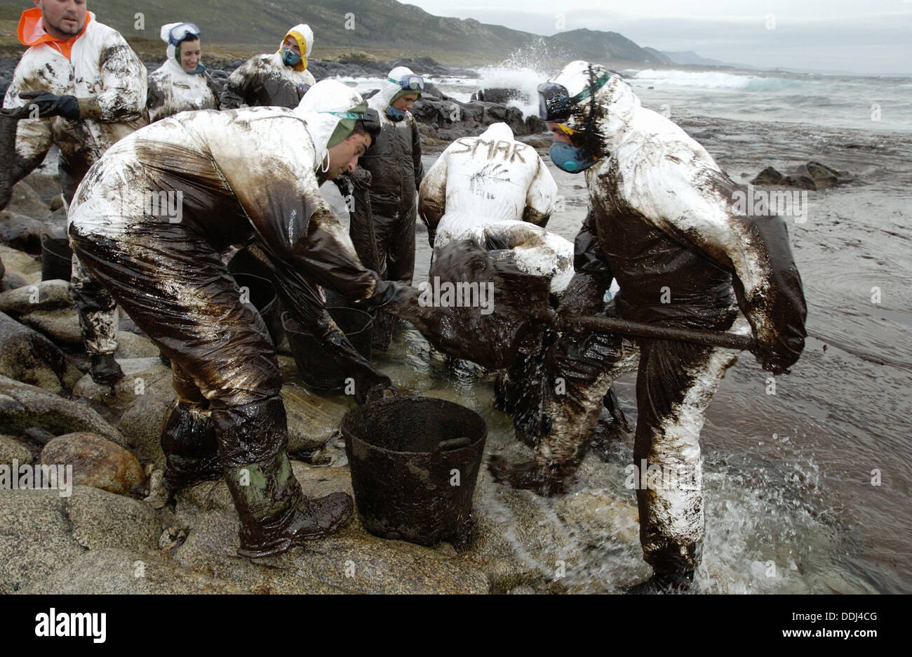 Soldiers dressed with protective clothing cleaning up the oil spill