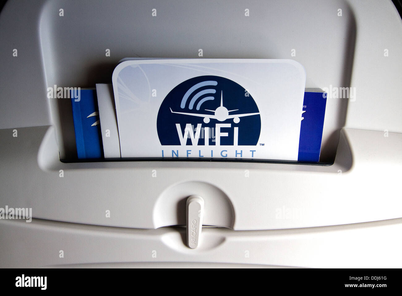 Inflight WiFi advertised on the back of airplane seat. WiFi the next generation of inflight entertainment. Stock Photo