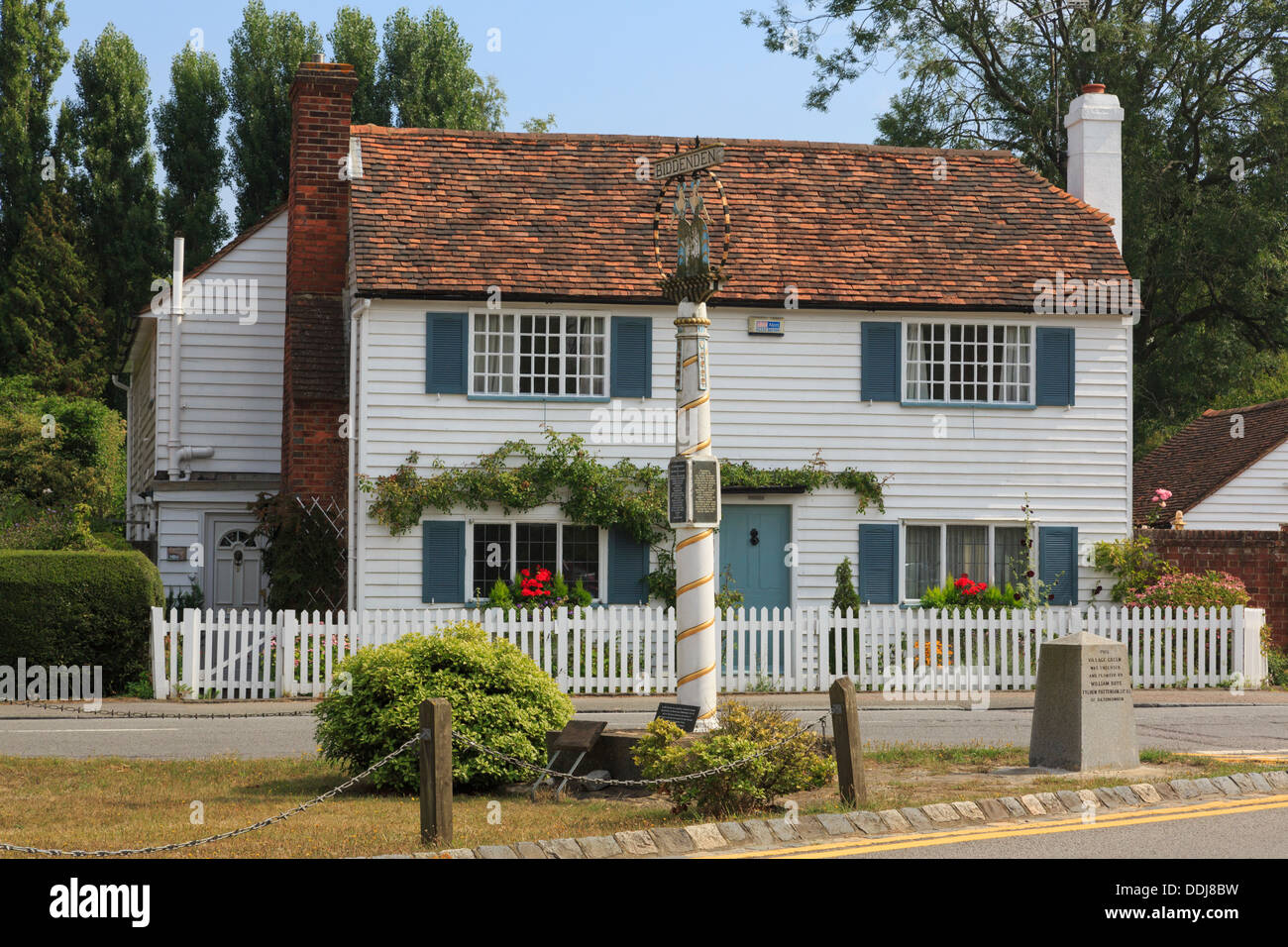 Village sign and Kentish white wooden clapboard cottage in Biddenden, Kent, England, UK, Britain Stock Photo