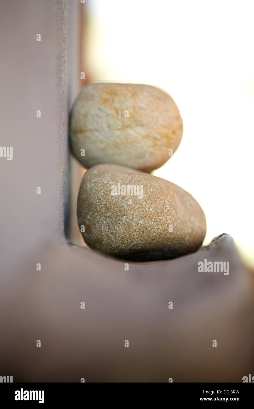 Stones leaning on a wooden shelf Stock Photo - Alamy