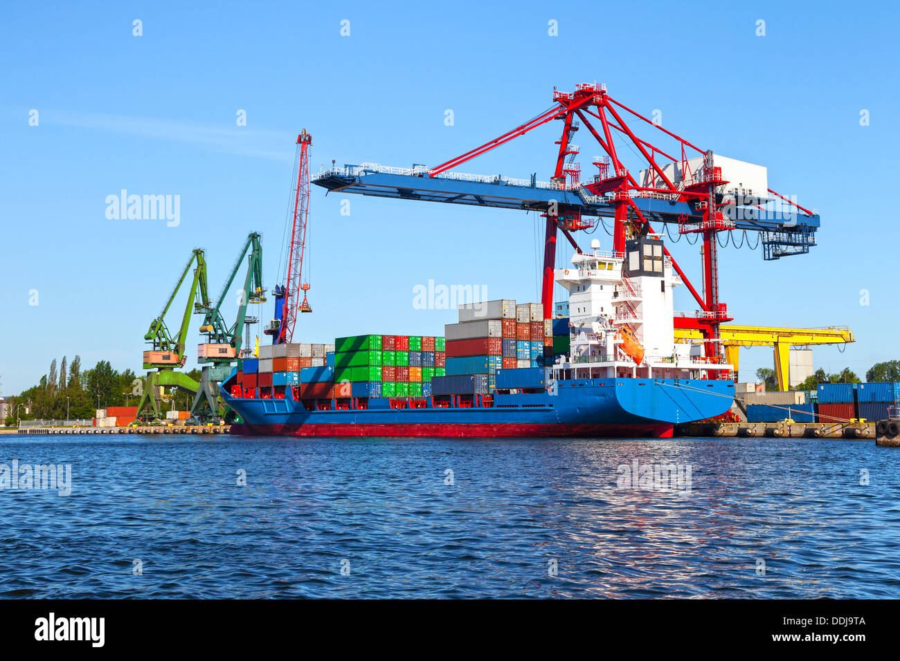 Seaport crane and huge container cargo ship ready for unloading Stock ...