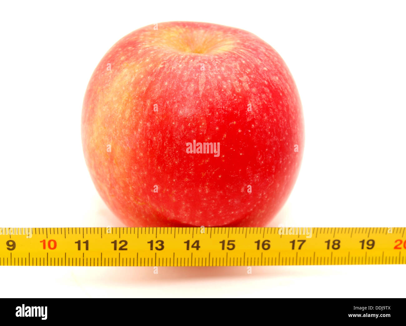 Apple and ruler on a white background Stock Photo