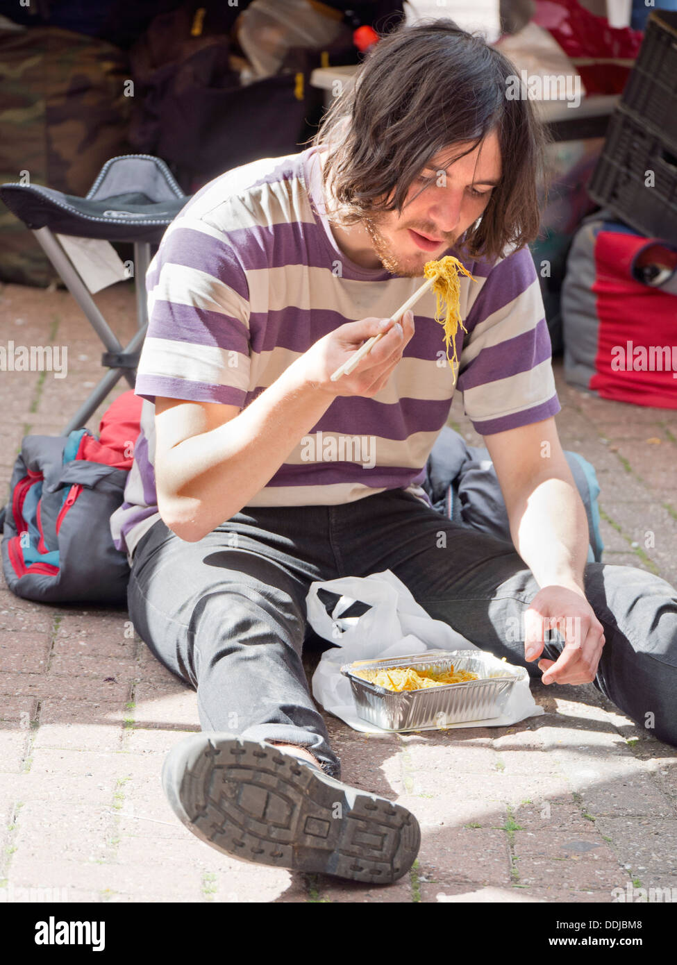 Flea Market in Gloucester Green, central Oxford - man eating noodles Stock Photo