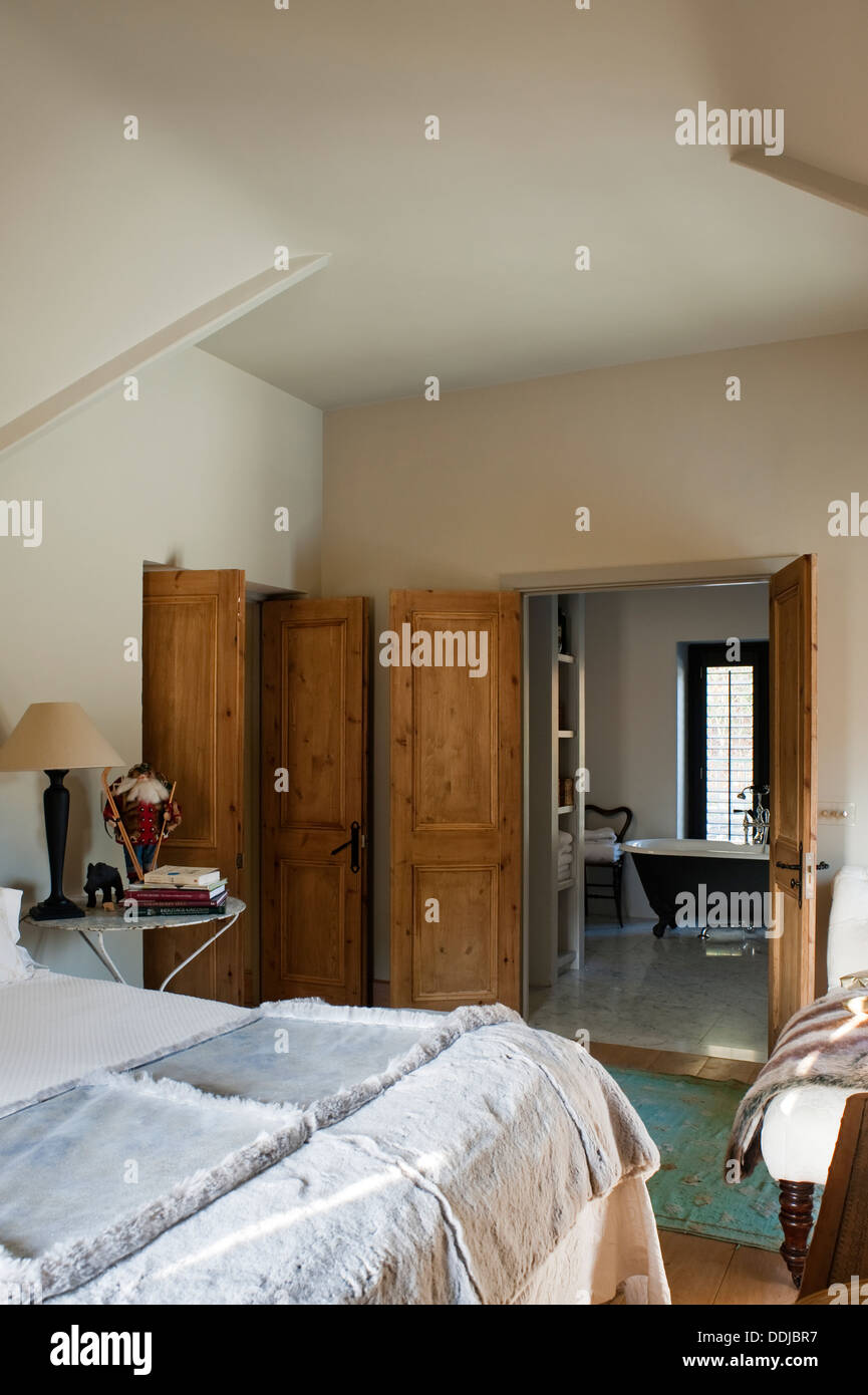 Master bedroom suite with daybed and view through to bathroom. Wall