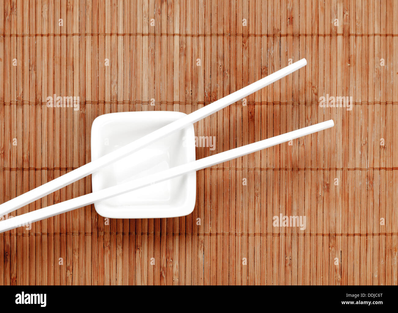 Chopsticks on a white ceramic cup Stock Photo