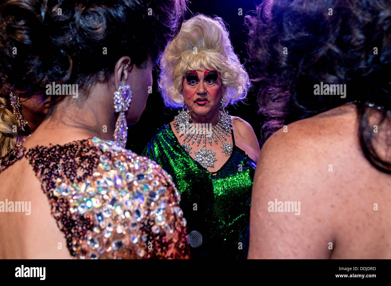 Portland, Oegon, USA. 01st Sep, 2013. DARCELLE, who has produced the La Femme Magnifique International Pageant for female impersonators for 32 years, speaks with contestants and friends after announcing that the 2013 pageant would be the very last one. La Femme contestants, anatomically correct males who adhere to a strict set of rules prohibiting surgical or hormonal changes to their bodies, rely on their illusionary artistry to wow the judges in four categories: formal, theme, talent and showgirl. However, it has become increasingly difficult to find contestants who've not taken hormon Stock Photo