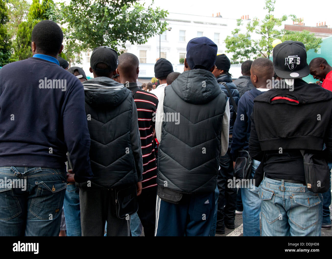 Back view of large group of youths together in London street Stock Photo