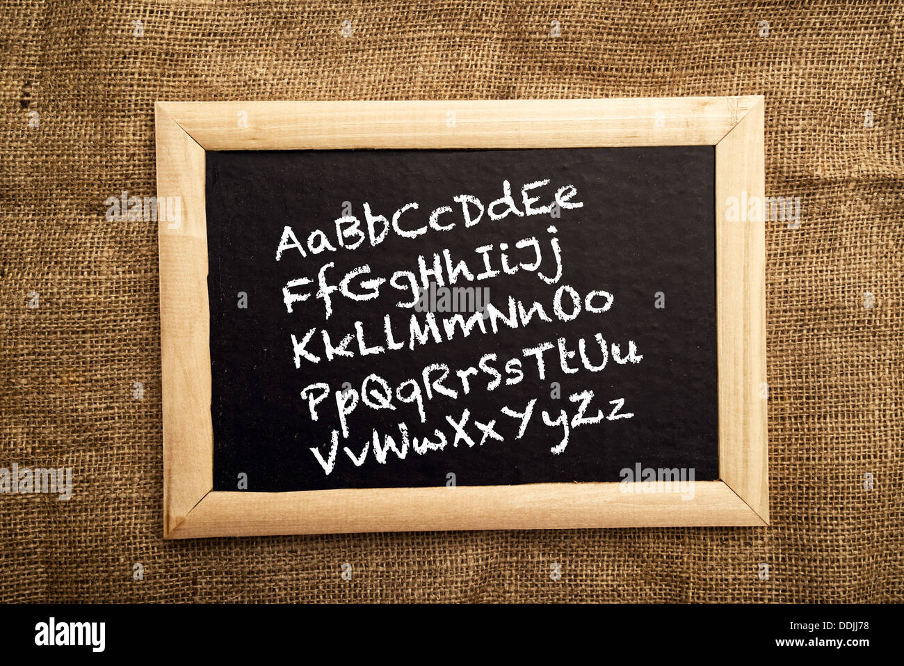 Learning ABC, letters on blackboard. Starting school and learning how to write. Stock Photo