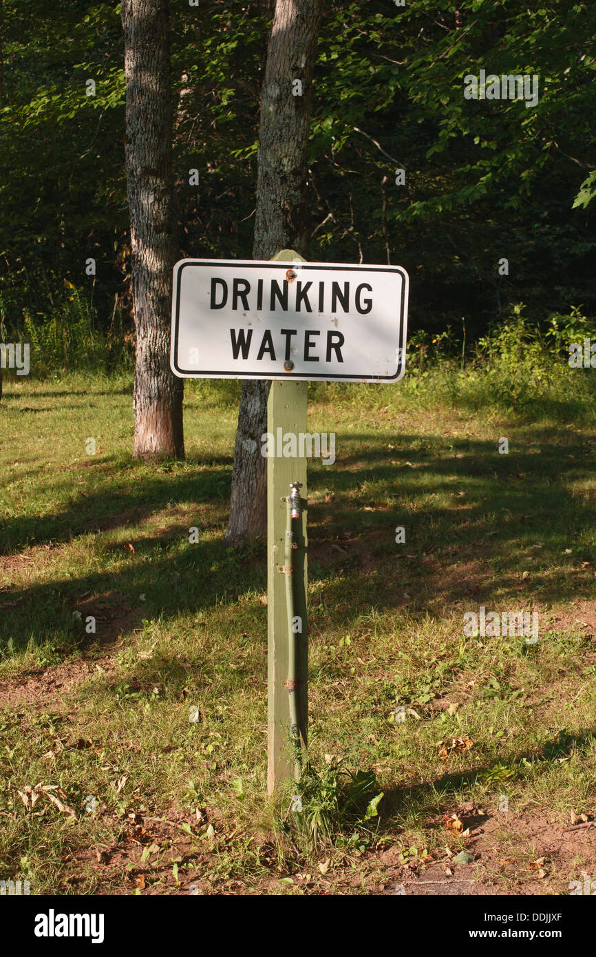 Drinking water sign and tap in rural park Stock Photo