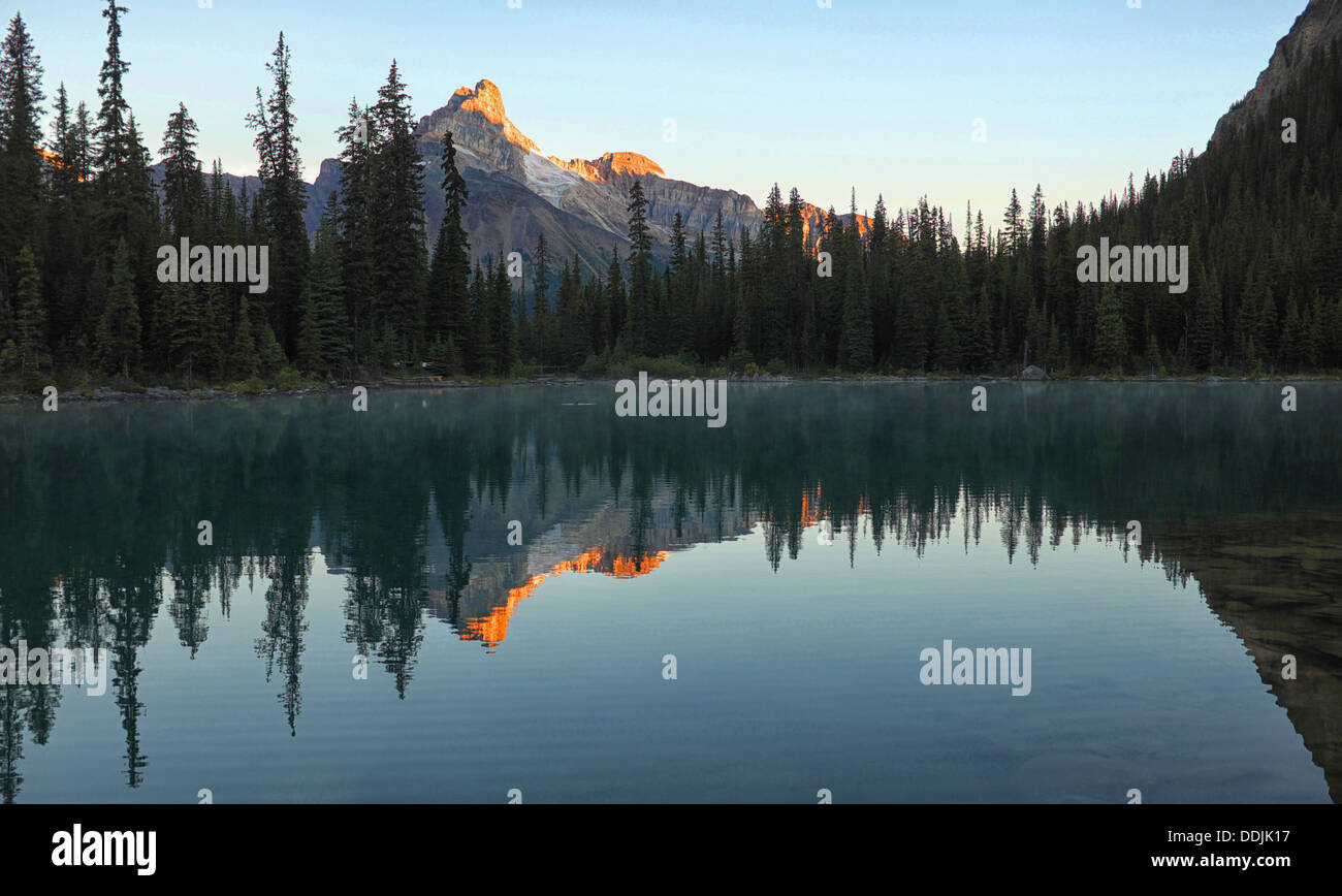 Mountains reflected in a clear calm alpine lake Stock Photo - Alamy