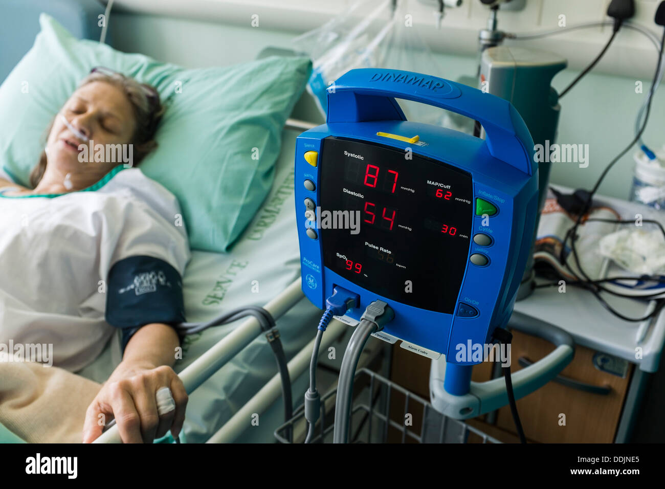 A woman recovering in a NHS hospital bed after having a hip replacement