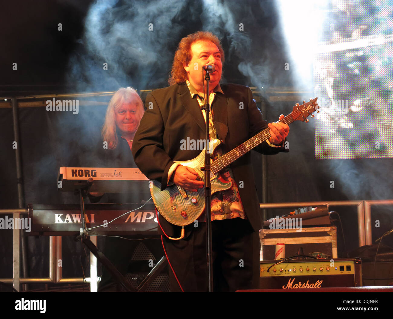 Bernie Marsden of Whitesnake at Silverstone 2013 British GP Grand Prix Woodlands stage with his guitar Stock Photo