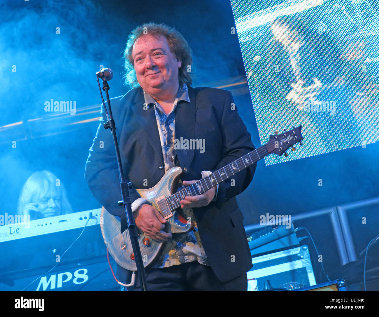 Bernie Marsden of Whitesnake at Silverstone 2013 British GP Grand Prix Woodlands stage with his guitar Stock Photo
