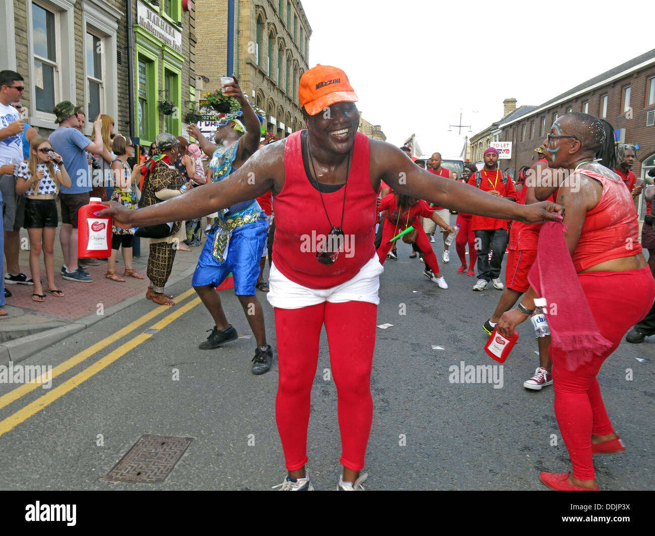 Costumed dancers in red from Huddersfield Carnival 2013 African Caribbean parade street party Stock Photo