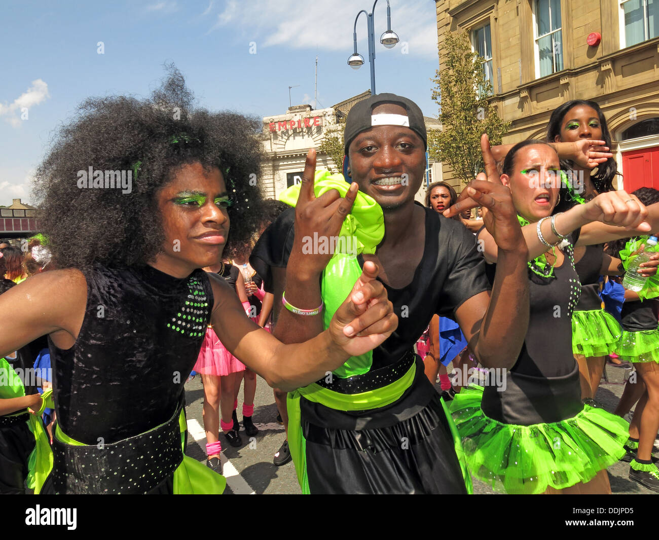 Costumed dancers in green from Huddersfield Carnival 2013 African Caribbean parade street party Stock Photo