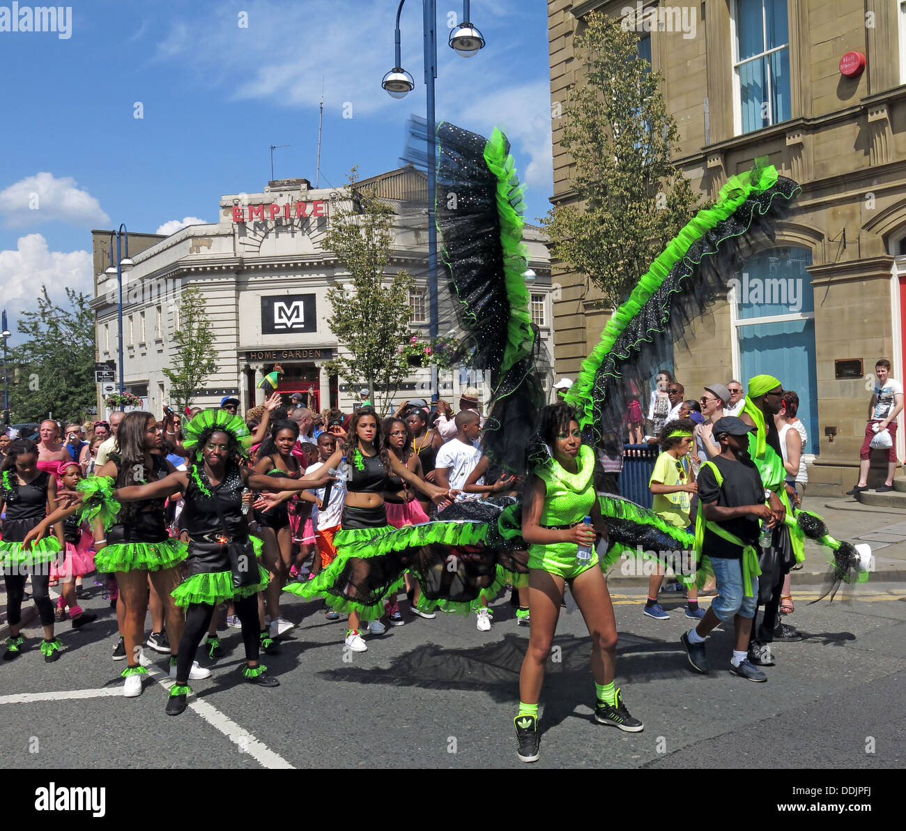 Costumed dancers in green from Huddersfield Carnival 2013 African Caribbean parade street party Stock Photo
