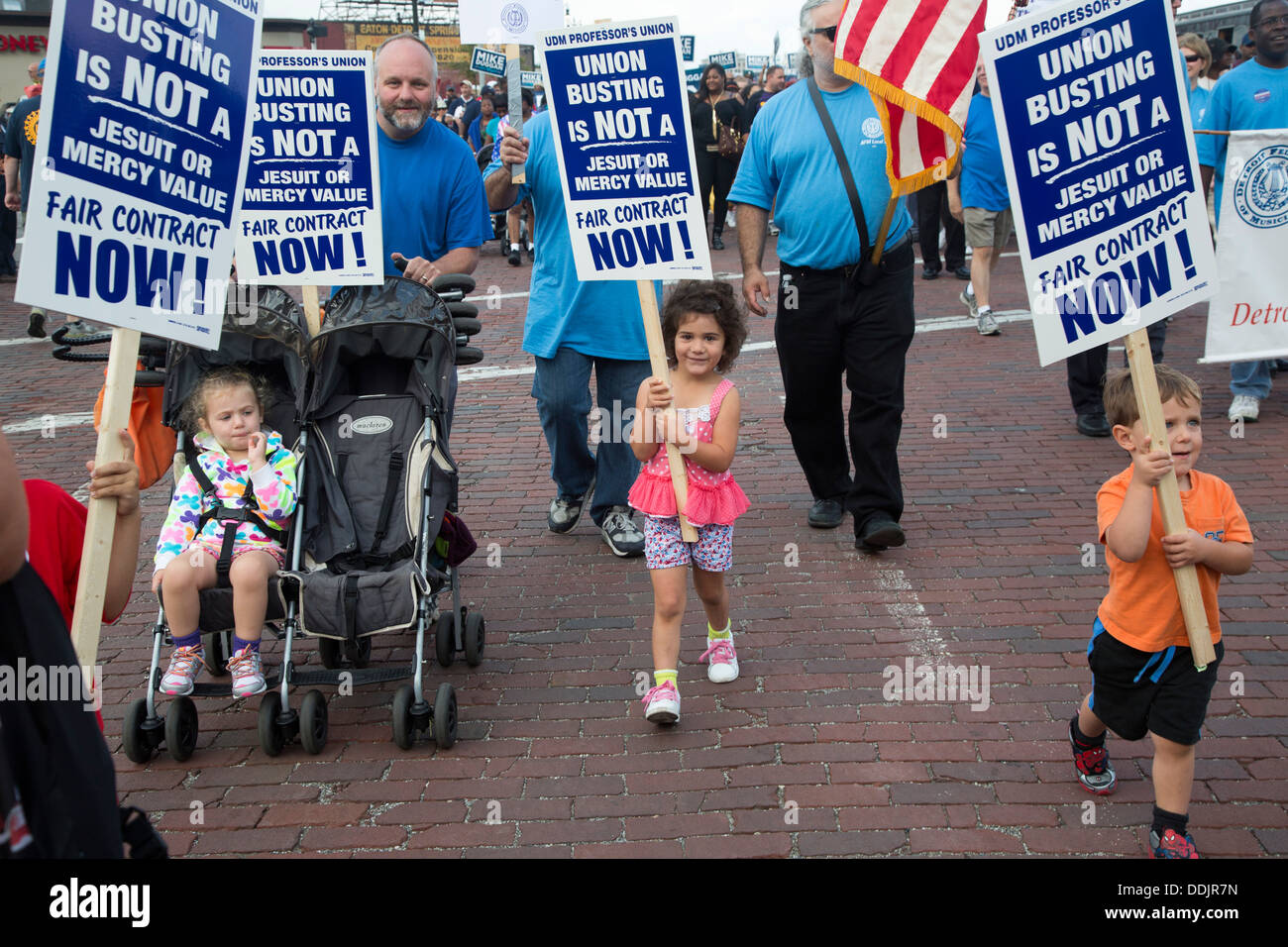 Professors from the University of Detroit Mercy, a Catholic university, march with their families in Detroit's Labor Day parade. Stock Photo