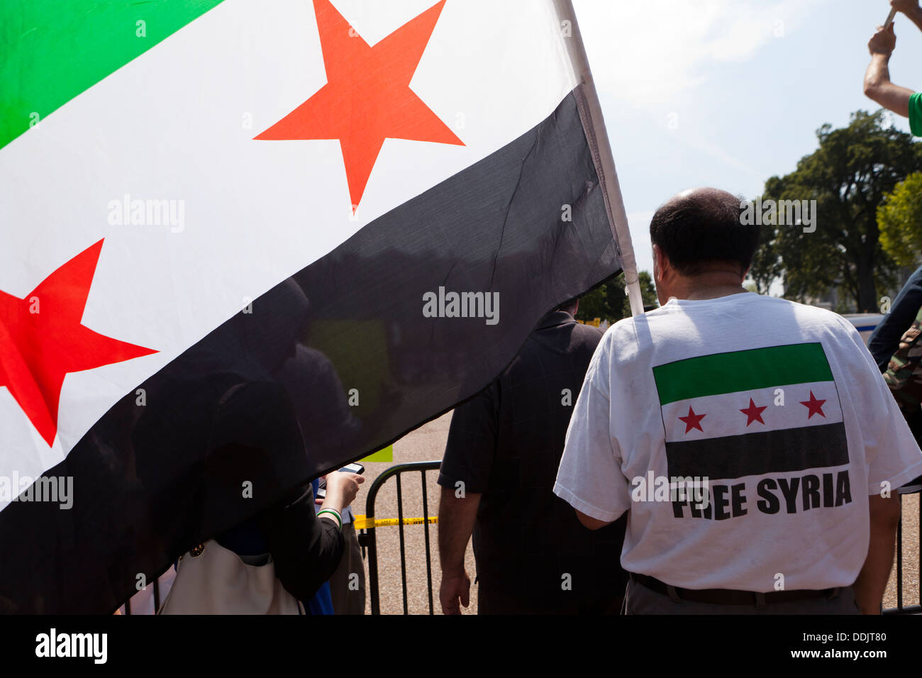 Man holding Syrian National Coalition flag Stock Photo