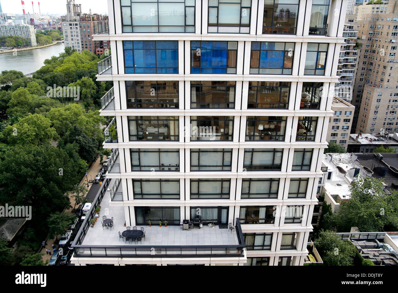 Looking Down at a New York City Condo Apartment Building Set-Back Terrace, New York City in the Background Stock Photo