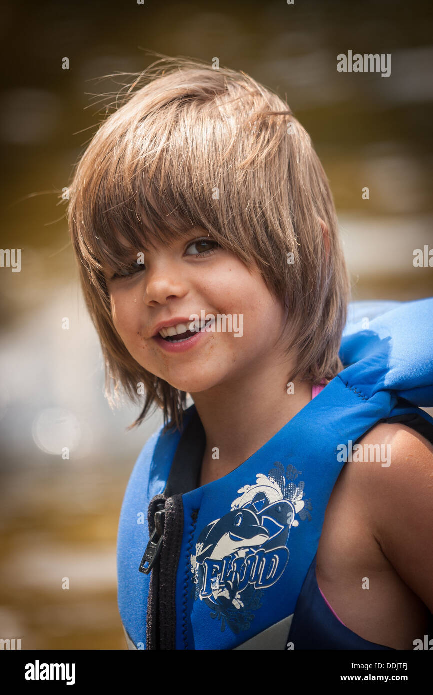 four-year-old girl wearing a blue life jacket Stock Photo