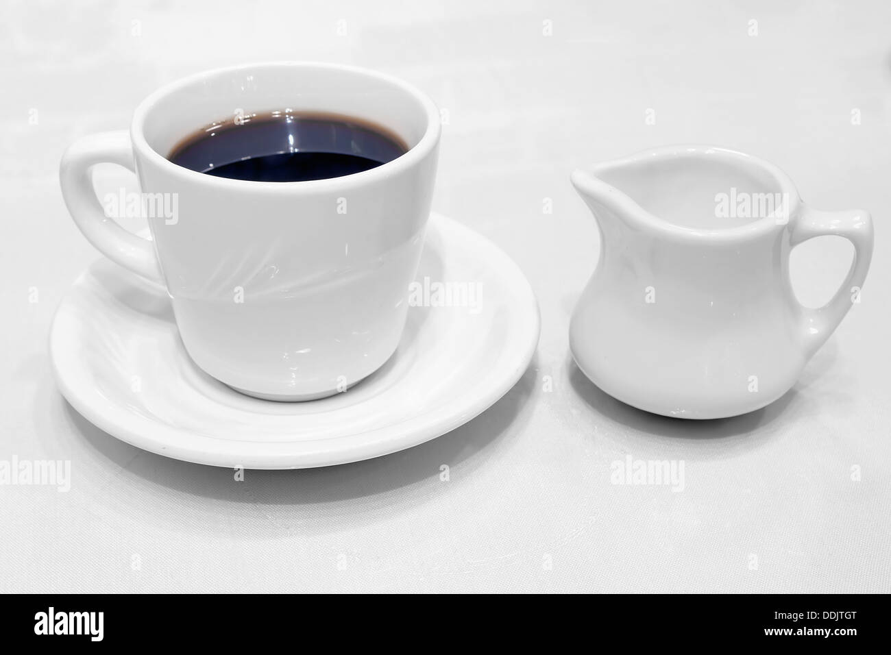Coffee Cup Saucer Creamer Whiteware with Black Coffee Stock Photo