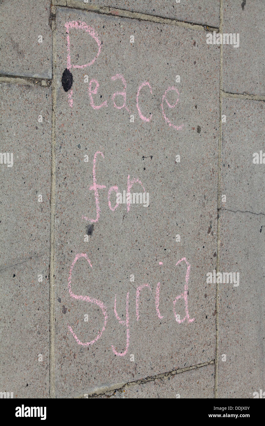 Words written in Pink Chalk on the Pavement outside Parliament London Protest for Syria 'Peace for Syria' Stock Photo