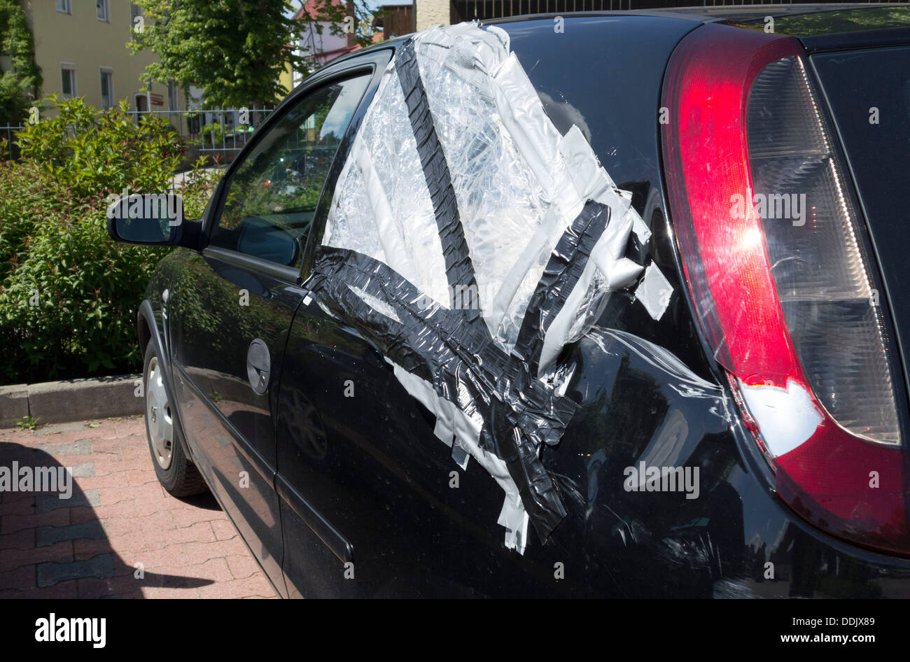 Broken side rear car window covered with plastic sheet, Chiemgau, Upper Bavaria Germany Europe Stock Photo