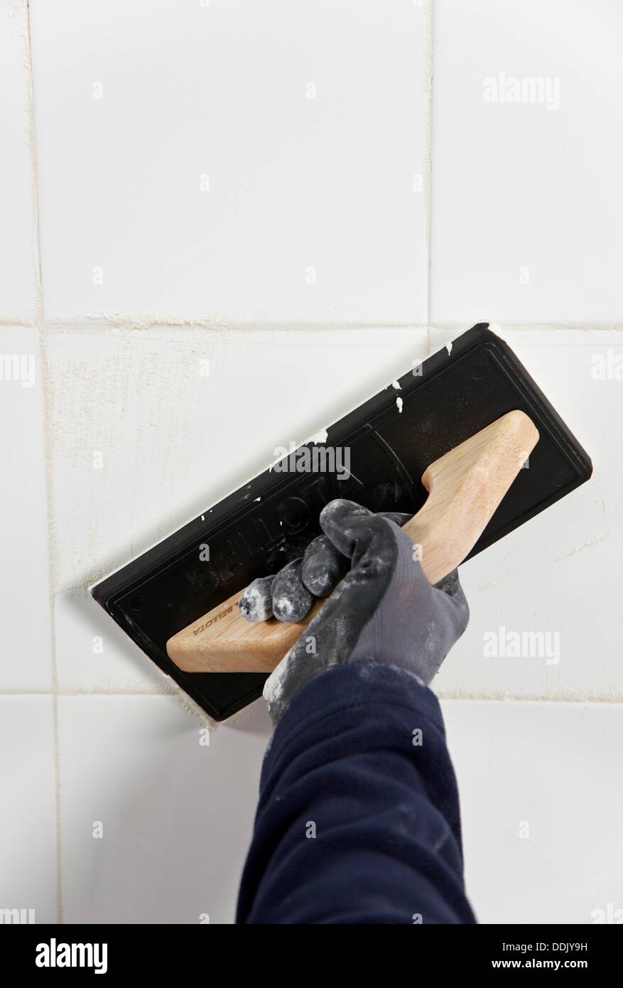 Laying tiles, glue mortar, using grout float, new homes under