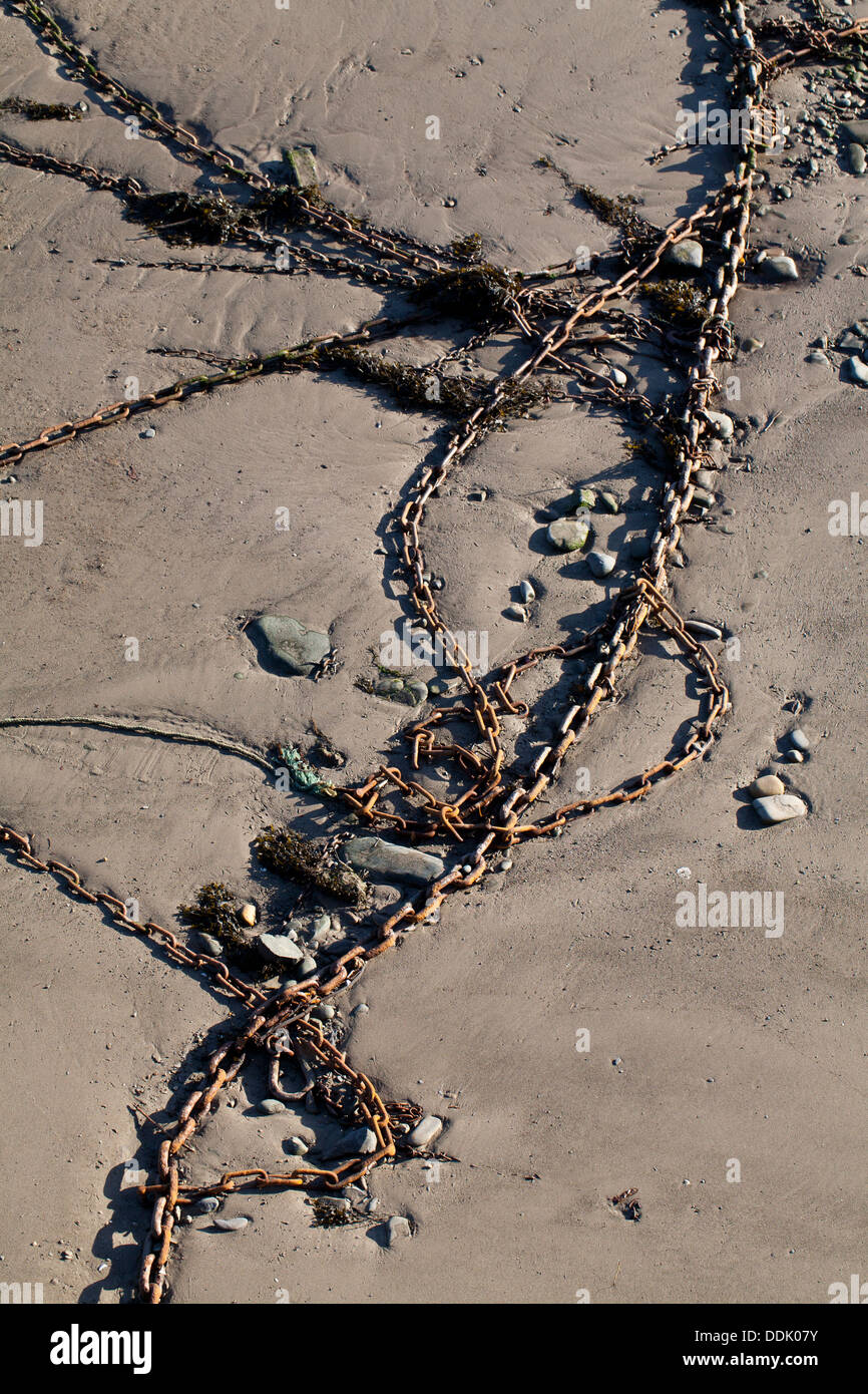 Boat mooring chains on the mud of a harbour at low tide. Aberystwyth, Ceredigion, Wales. January Stock Photo