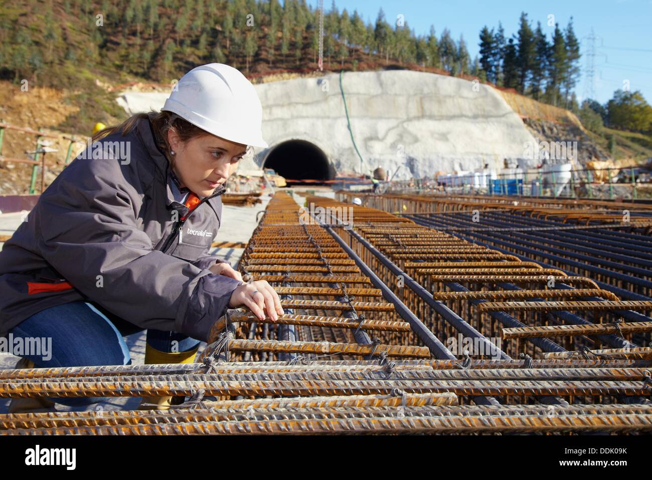 Architect overseeing the installation of rebar, reinforcing steel bars