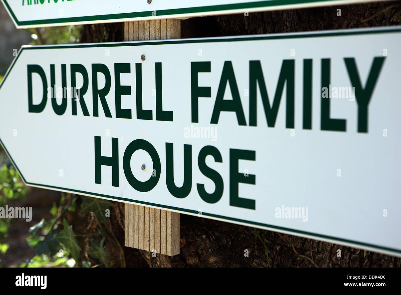 Sign in the Corfu village of Kalami pointing toward the home of authors, Gerald and Lawrence Durrell Stock Photo