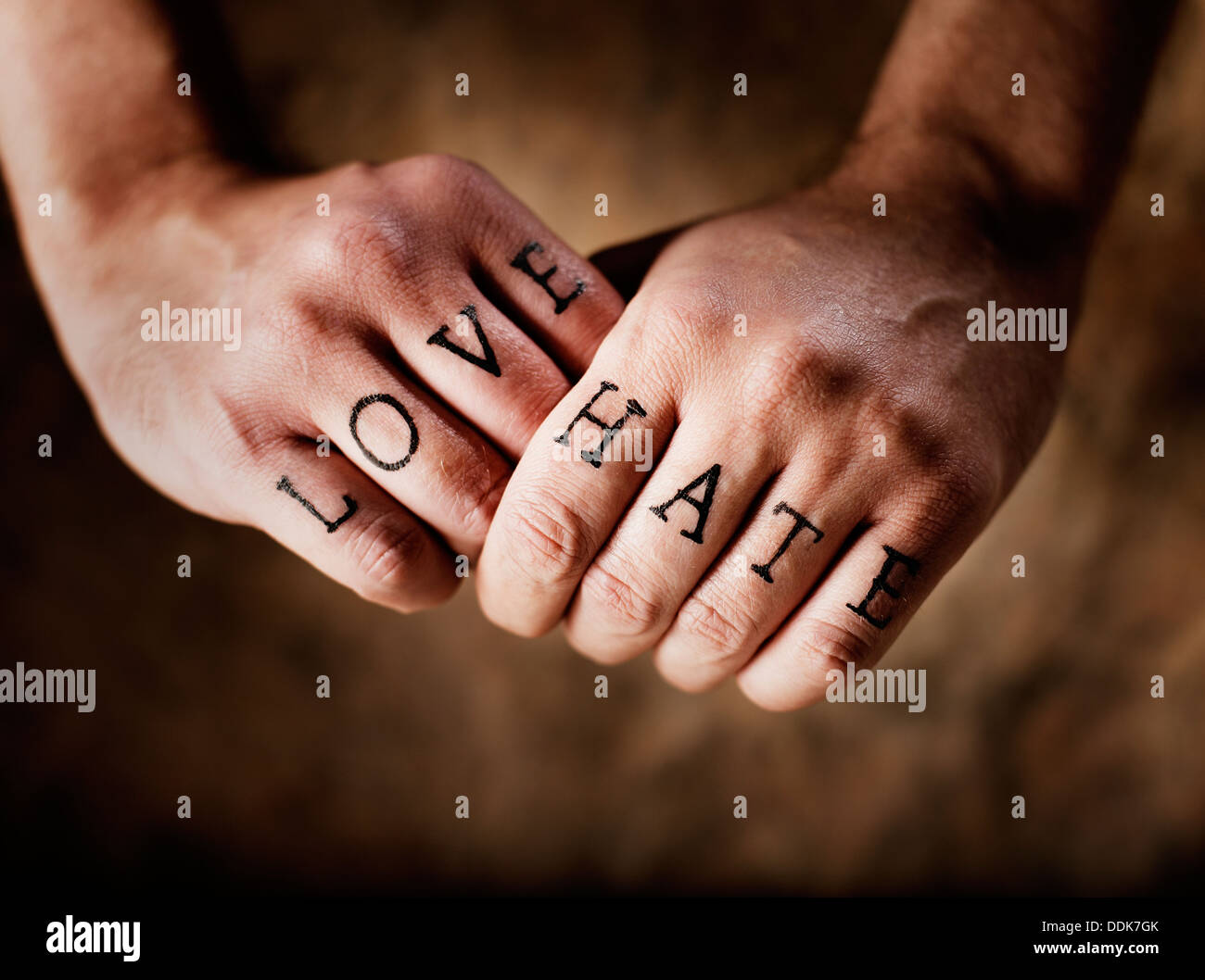 Man with (fake) Love and Hate knuckle tattoos. Stock Photo