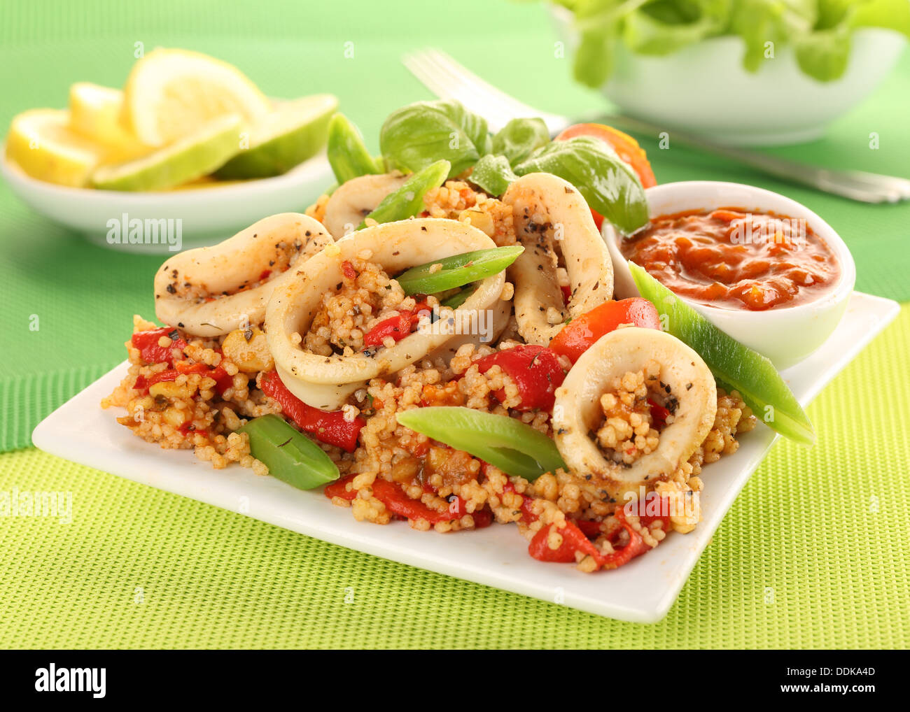 SQUID OR CALAMARI AND COUSCOUS SALAD WITH PEPPERS AND GREEN BEANS Stock Photo