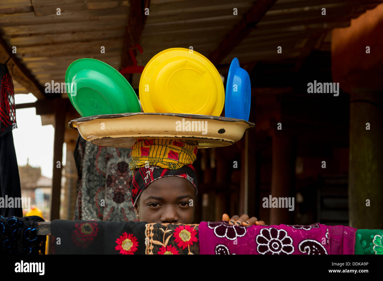 Black African woman head carrying dishes Stock Photo