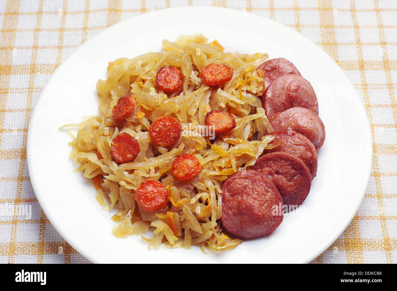 Braised cabbage with sausage on a table Stock Photo